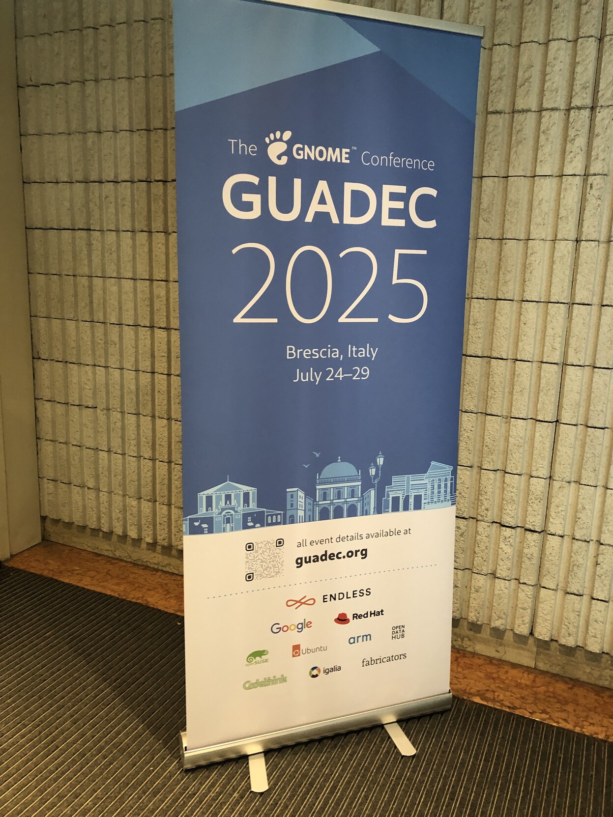 Upright banner for GUADEC 2025 at the school of engineering in the University of Brescia.
